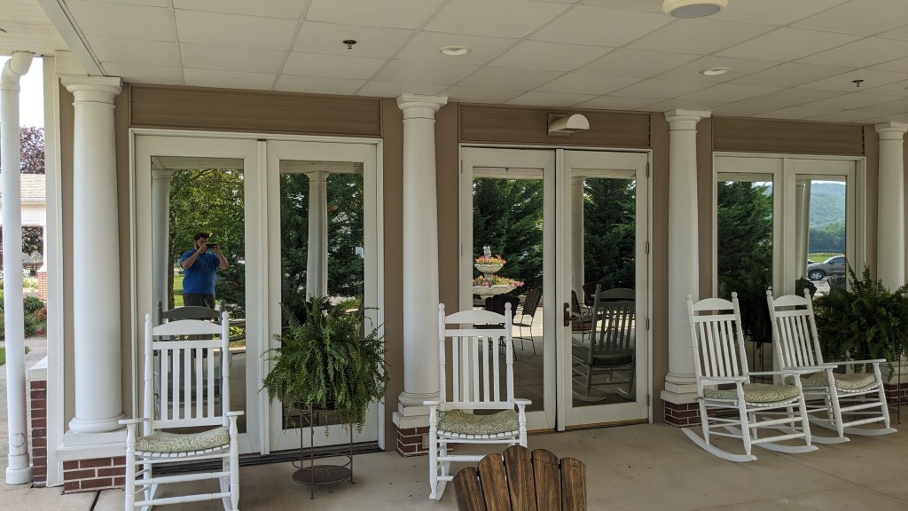 Breezeway with patio chairs and mirrored finish windows